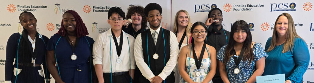 A group photo of Take Stock in Children scholars at Senior Celebration night wearing their medals and cords.
